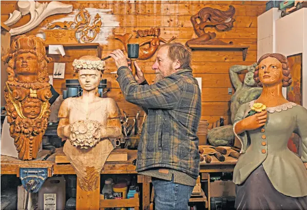  ?? ?? Andy Peters, Britain’s last ship’s carver, works on an original figurehead at his workshop in Waterperry, Oxon. The 67-year-old said he spent more than a decade restoring carvings made for the owners of superyacht­s