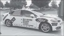  ?? THE ASSOCIATED PRESS ?? This specially designed delivery car will be used by Ford Motor Co. and Domino’s Pizza to test self-driving pizza deliveries.