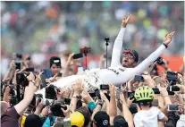  ?? Picture / AP ?? Lewis Hamilton somehow still had the energy after his British Grand Prix win to celebrate with fans at Silverston­e.