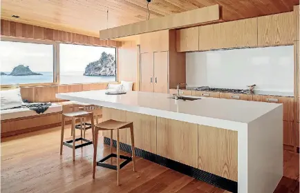  ??  ?? American oak veneer cabinets are teamed with white Caesarston­e in the kitchen in this beach house designed by architect Paul Clarke of Studio2 Architects.