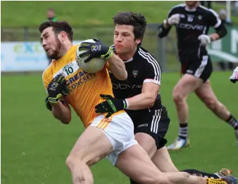  ??  ?? Brendan Egan of Sligo tries to hold off an attack from Antrim’s Conor Murray in Corrigan Park, Belfast. Pic: Eamonn McMunn.