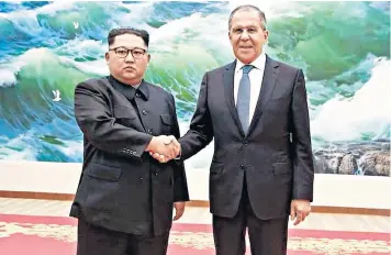  ??  ?? Russian TV appears to have put a smile on Kim Jong-un’s face, top, compared with the picture of him and Sergei Lavrov released earlier