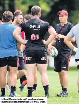  ??  ?? &gt; Brad Mooer chats to Crusaders players during an open training session this week