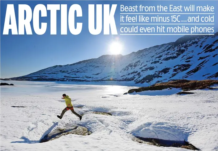  ?? By Inderdeep Bains ?? Look before you leap: A walker on the frozen edges of Red Tarn on Helvellyn in the Lake District yesterday. Snow and ice will spread to most of the UK this week