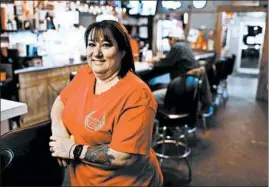  ??  ?? Sherry Pecord, owner of the Horseshoe Bar & Grill in Olive Branch, Illinois: “Did I have to boat home for 130 days? Yeah. Was that a pain ... ? Yeah. But do I love where I live? Yeah.”