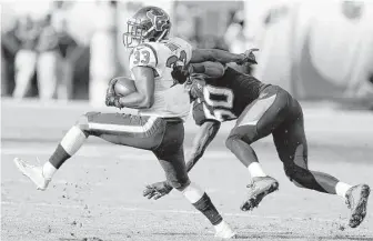  ??  ?? Texans running back Akeem Hunt (33) is hit by Jaguars outside linebacker Telvin Smith (50) during the fourth quarter Sunday in Jacksonvil­le. Hunt gained 52 yards yards on eight carries.