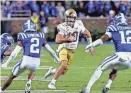  ?? BEN MCKEOWN/AP ?? Notre Dame’s Sam Hartman (10) carries the ball for a critical first down against Duke in Durham, N.C. on Saturday.