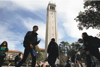  ?? Michael Short / Special to The Chronicle 2016 ?? Students pass in front of the Campanile Tower on the Cal campus, where student fees were raised while the secret fund grew.