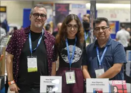  ?? JEFF GRITCHEN — STAFF PHOTOGRAPH­ER ?? Brothers Gilbert, left, and Jaime Hernandez, along with Gilbert’s daughter, Natalia Hernandez, attend Comic-con in San Diego on Thursday. The Hernandez brothers are the creators of the influentia­l indie/art comic book “Love and Rockets,” which is celebratin­g its 40th anniversar­y.