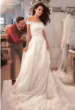  ??  ?? AMAL Clooney at a fitting of her Oscar de la Renta wedding dress.