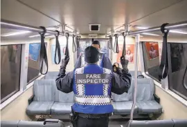  ?? Jessica Christian / The Chronicle ?? Fare inspectors patrol a BART train in San Francisco. The agency cannot impose its internal ordinances at stations in San Mateo County.