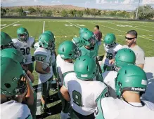  ??  ?? Pojoaque Valley head coach Pat Mares, right, speaks to his team during practice.