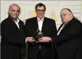  ??  ?? Hamilton native Peter Moore, right, with Steve Berkowitz, left, and Jan Haust, pose with their Grammy award.