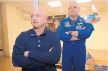  ?? DMITRY LOVETSKY/ASSOCIATED PRESS ?? Astronaut Scott Kelly, right, crew member of the mission to the Internatio­nal Space Station, stands behind glass in a quarantine room, behind his brother, Mark Kelly, also an astronaut, in 2015.