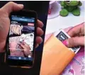  ?? — AFP ?? This illustrati­on picture shows the ‘cash stuffing’ TikTok trend, videos where people put cash in envelopes as a budgeting method, displayed on a smartphone in Washington, DC.