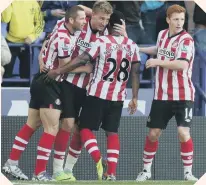  ??  ?? Sunderland celebrate Nicklas Bendtner’s late clincher at Bolton.