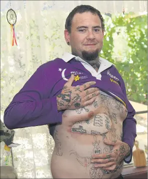  ??  ?? PERMANENT REMINDER: James Crute’s patchwork of tatoos is the result of multiple surgeries to remove a cancerous growth on his ribcage.Picture: PAUL CARRACHER