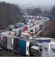  ?? (AP/dpa/Robert Michael) ?? Trucks jam the A4 motorway Tuesday near Bautzen, Germany, as a result of coronaviru­s controls at the border with Poland.