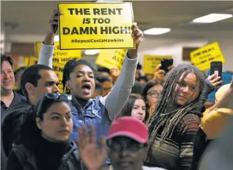  ?? Paul Chinn / The Chronicle ?? Sasha Graham (left) of Richmond joins other tenants rights supporters before a joint hearing in Sacramento in June on the ballot measure to repeal the Costa-Hawkins rental housing act.