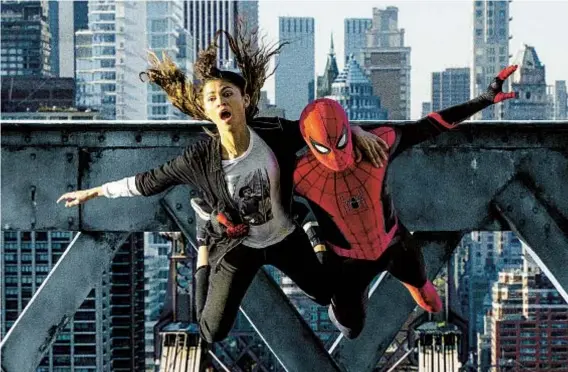  ?? MATT KENNEDY SONY PICTURES ?? MJ (Zendaya) and Spider-Man (Tom Holland) jump off the bridge in the new movie “Spider-Man: No Way Home.”