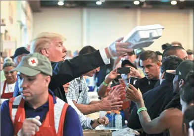  ?? NICHOLAS KAMM / AFP ?? US President Donald Trump serves food to Hurricane Harvey victims in Houston on Saturday.
