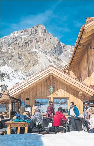  ?? Photos by Susan Wright, © The New York Times Co. ?? Skiers enjoy Rifugio Fuciade, an alpine inn and former priest’s retreat in the Dolomite Range of northeaste­rn Italy, in March.