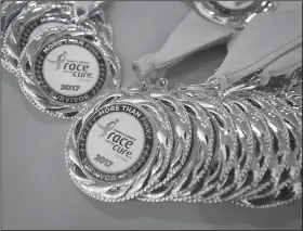  ?? NWA Democrat-Gazette/BEN GOFF • @NWABENGOFF ?? Survivor medals sit on a table during the survivor reunion breakfast Saturday.