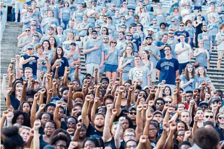  ??  ?? Saying no: North Carolina Tar Heels students holding up their fists during the national anthem in silent protest during the game against the Pittsburgh Panthers at Kenan Memorial Stadium. — Reuters