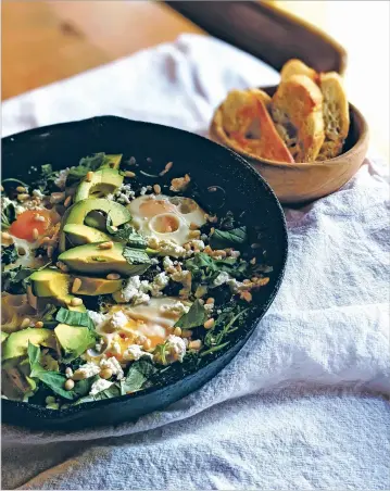  ?? COURTESY MARIANNE SUNDQUIST ?? This egg and greens skillet served with grilled bread can be served for breakfast, lunch or dinner.