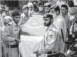  ?? RIZWAN TABASSUM/GETTY-AFP ?? Troops carry the coffin of Pakistani Army Maj. Shaheryar Baloch during his funeral Saturday. Baloch was one of 97 people killed after a plane crashed Friday in Karachi.