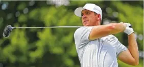  ?? AP FILE PHOTOS ?? Keith Mitchell, left, hits his tee shot on the 15th hole during the third round of the Houston Open golf tournament in March. Luke List follows his tee shot on the 17th hole during the first round of the Bridgeston­e Invitation­al at Firestone Country Club in August. The two pro golfers played the sport at Baylor School.