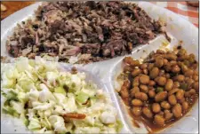  ?? Arkansas Democrat-Gazette/ROSEMARY BOGGS ?? A chopped pork and beef barbecue plate at the Smoke Shack in Maumelle is served with potato salad, baked beans and a toasted bun.