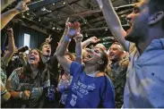  ?? Gali Tibbon / AFP/Getty Images ?? Supporters of the centrist Blue and White party cheer as exit polls show a tight race.