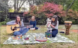  ?? CONTRIBUTE­D BY BRYAN PIRAS VIA AP ?? Music therapists for St. Jude Children’s Research Hospital (from left) Celeste Douglas, intern Abigail Parrish and Amy Love record a session in Love’s backyard in Memphis, Tennessee. The group uploads their weekly sessions to YouTube so patients can continue receiving bedside music therapy.