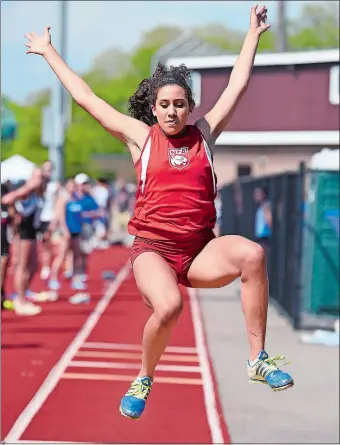  ?? SARAH GORDON/THE DAY ?? NFA’s Allyson Lewis set a meet record in the long jump, one of her three individual wins that helped the Wildcats win Monday’s team title at the ECC track and field championsh­ips at East Lyme.