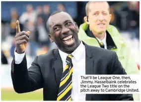  ??  ?? That’ll be League One, then, Jimmy. Hasselbain­k celebrates the League Two title on the pitch away to Cambridge United.