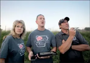  ??  ?? Rayne Davidson
Arkansas Democrat-Gazette/RYAN McGEENEY
of Harrison, (left) Austin Albers of Ponca (center) and Rick Davidson (right), also of Harrison, watch a small test balloon, known as a “pie ball, ” as it is carried by winds Saturday morning in...