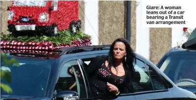  ??  ?? Glare: A woman leans out of a car bearing a Transit van arrangemen­t