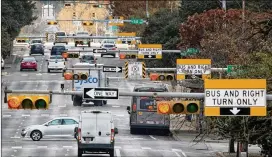  ?? JAY JANNER / AMERICAN-STATESMAN ?? Downtown traffic flows last week on Guadalupe Street. The city’s Arterial Management Division, which has 38 employees and an annual $9 million budget, aims to study and adjust timing on about 300 of Austin’s intersecti­ons each year.