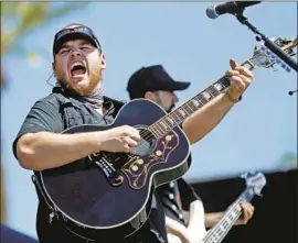 ?? Allen J. Schaben Los Angeles Times ?? LUKE COMBS, above at Stagecoach in 2017, has a spotlight performanc­e at the festival in Indio on Saturday night, just a heartbeat away from headliner status.