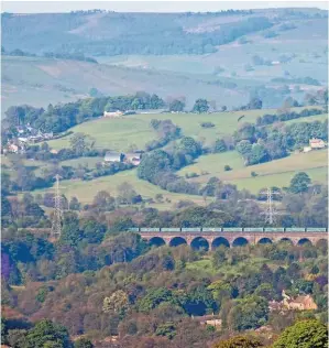  ?? ROBERT FALCONER. ?? A Freightlin­er Class 66 crosses the viaduct on the approach to Chinley South Junction (Derbyshire) on May 19, with a Tunstead-Garston aggregates train. Rail freight contribute­s almost £1.2 billion of productivi­ty gains, according to a new report.