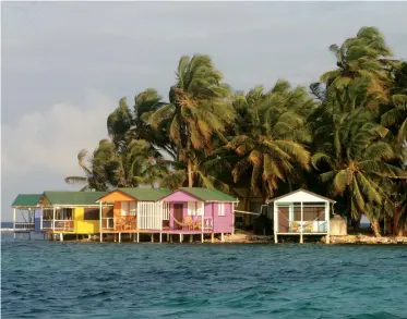  ??  ?? Our view from our anchorage off the north side of the island included these colorful overwater cabanas.