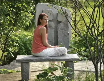  ?? JOHN RENNISON, THE HAMILTON SPECTATOR ?? Sharlene Bosma spends a quiet moment in the memory garden dedicated to her husband Tim at their Ancaster home.