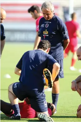  ??  ?? Malta national team coach Pietro Ghedin (right) oversees a slight injury during training to Alfred Effiong
Photo: Domenic Aquilina