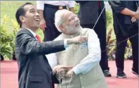  ?? — AFP ?? Joko Widodo and Narendra Modi fly kites after launching the India-indonesia kite exhibition at the National Monument in Jakarta on Wednesday.