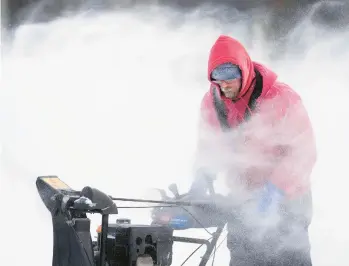  ?? CHARLIE NEIBERGALL/AP ?? Mark Sorter braves bone-chilling cold to clear snow from a skating rink Friday in Des Moines, Iowa.