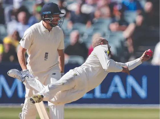  ?? Picture: AP PHOTO ?? Australia's Nathan Lyon is watched by England's Jonny Bairstow as he catches out England's Moeen Ali.