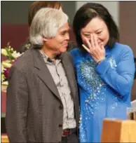  ?? Photos and text from wire services ?? Associated Press staff photograph­er Nick Ut, left, meets Phan Thi Kim Phuc during a presentati­on at the Liberty Baptist Church in Newport Beach “That picture changed my life. It changed Kim’s life,” he says of the pair’s chance meeting in a dusty Vietnamese village called Trang Bang. He’d just finished photograph­ing four planes flying low to drop the napalm that would set Phuc’s village ablaze when he saw a terrified group of men, women and children running for their lives from a pagoda.