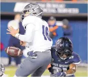  ?? ELI LUCERO/ASSOCIATED PRESS ?? Nevada quarterbac­k Malik Henry (16) fumbles after being hit by Utah State’s Andre Grayson during their game Saturday in Logan, Utah. Henry has since been replaced.