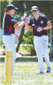  ??  ?? Tiana Atkinson is congratula­ted by captain Erin Maxwell in the Division 6 match between Longwarry and Catani.